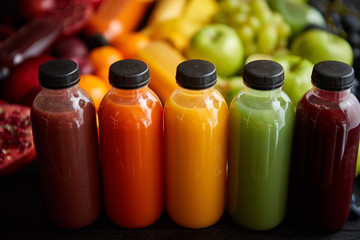 Colorful bottles filled with fresh fruit and vegetable juice or smoothie
