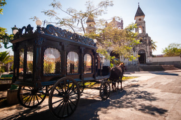 funeral wagon with horse in front of old church