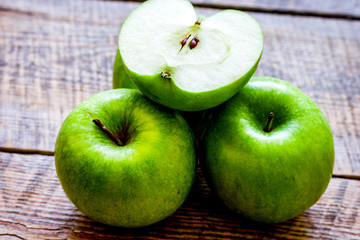 Healthy green food with apples on kitchen wooden background