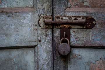 old rusty lock on wooden door