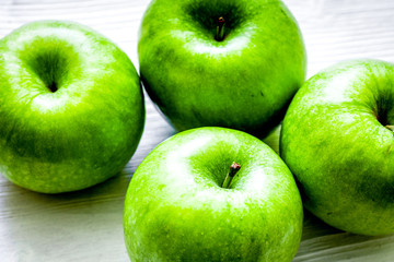 ripe green apples white table background