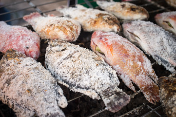 Closeup of roasting fish with salt