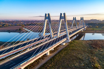 New modern double cable-stayed bridge with wide three-lane roads over Vistula River in Krakow,...