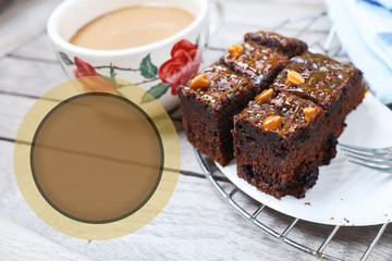 Brownies on the cooling rack with a cup of coffee isolated on a wooden table.  Food and drinks concept