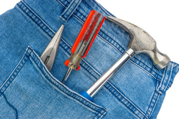 Jeans, screwdriver, hammer and pliers on white background. Jeans texture, Blue denim jeans with tools. Copy space concept