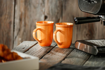 Morning coffee on a wooden table in the light of the sun