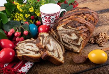 Traditional Romanian Easter table with cozonac and pasca meaning Sweetbread and Matzo an unleavened flatbread that is part of Jewish cuisine and forms an integral element of the Passover. Happy Easter