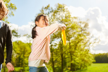 Naklejka na ściany i meble Girl playing frisbee in the summer