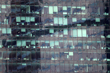 Empty offices in skyscraper during covid-19 coronavirus pandemic. Windows of modern city building during quarantine, concept of economy and business