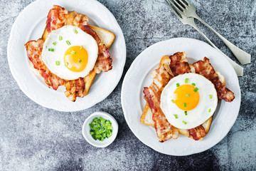 Fried egg fried bacon sandwiches on a light background