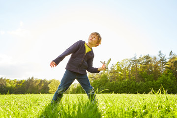 Boy is playing in the park with a model airplane