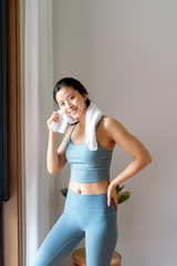 A young Asian woman exercising indoors