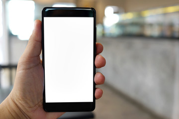 Cropped shot view of man hand holding a smartphone in the cafe with blank copy space screen for text message or information content