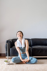 A young Asian woman eating healthy food after indoor exercise