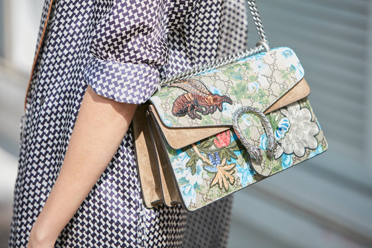 Woman with Gucci bag with floral decoration on September 23, 2016 in Milan, Italy
