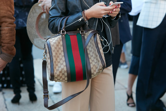 Woman with Gucci bag with green and red stripes on September 21, 2017 in Milan, Italy