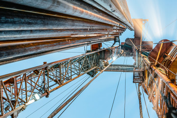 Oil and Gas Drilling Rig onshore dessert with dramatic cloudscape. Oil drilling rig operation on...