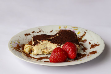 tiramisu dessert, strawberries in white plate.