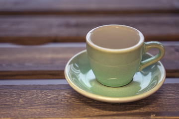 Colorful ceramic cup on wooden table for espresso