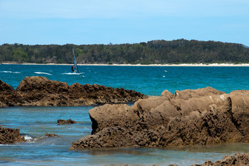 Candlagan Creek Australia, windsurfer on bay with forested headland in background