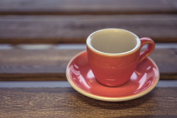 Colorful ceramic cup on wooden table for espresso