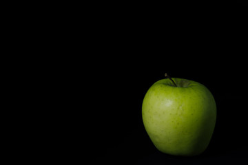 green Apple on black background,