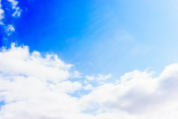 Naklejka na ściany i meble White fluffy clouds floating in the blue summer sky. Cloudy serene landscape.