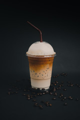 Ice latte coffee  with milk in black background