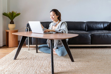 A young Asian woman in a sports office at home