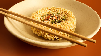instant noodles with dry seasoning brown bowl, raw noodles. Vegetarian dish. Delicious Asian style dinner. pasta, for the preparation of which it is enough to pour boiling water and wait.