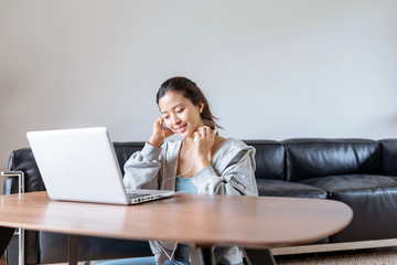 A young Asian woman in a sports office at home