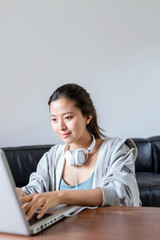 A young Asian woman in a sports office at home