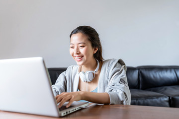 A young Asian woman in a sports office at home