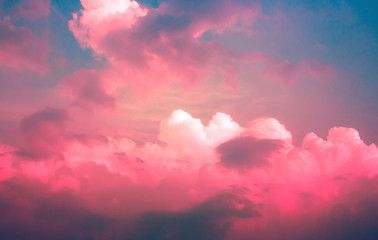 bright red pink neon Light on clouds with dim blue sky
