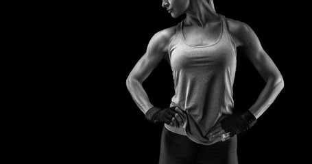 Fitness woman in sports tank top, short sleeve tee, gloves. Black and white close-up photo with...