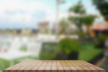 Empty wooden table top with lights bokeh on blur restaurant background, 3D Rendering