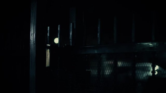 A gate opens, and then closes, in in a dark + urban apartment complex.

Tripod. Fixed Focus. Medium Close-Up. 23.976 FPS. 4K.