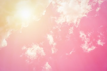 Fototapeta na wymiar Sunny orange pink sky background. Beautiful warm sky with clouds. Toned photo