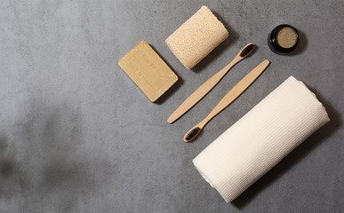 Zero waste tools for personal hygiene. Eco toothbrush, olive soap, cotton towel, tooth-powder and cotton swaps. Free space for text.