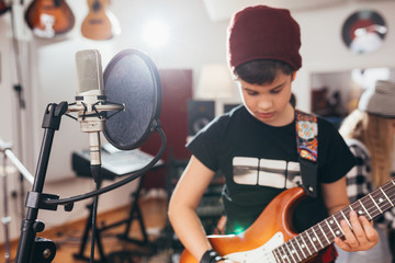 kids rock band practice in music studio