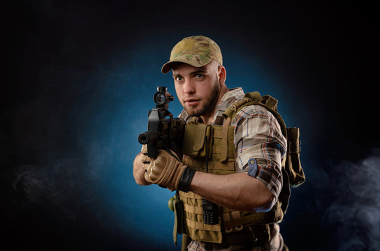 guy's a military agent in a bulletproof vest with an automatic rifle