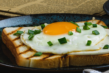 fried eggs on toast with hot coffee