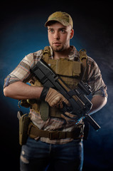 guy's a military agent in a bulletproof vest with an automatic rifle