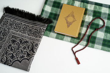 Islamic Holy Book Quran with prayer beads on White Background. Ramadan concept