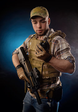 guy's a military agent in a bulletproof vest with an automatic rifle
