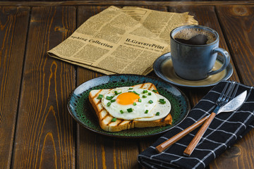 fried eggs on toast with hot coffee