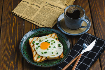 fried eggs on toast with hot coffee