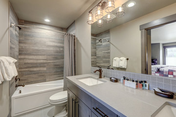 Natural new classic bathroom interior with new glass small walk in shower.