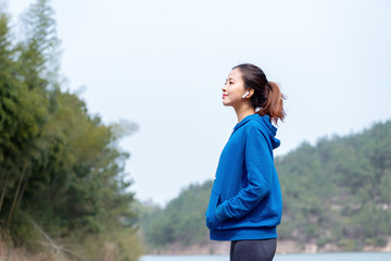A young Asian woman practicing yoga in the outdoors