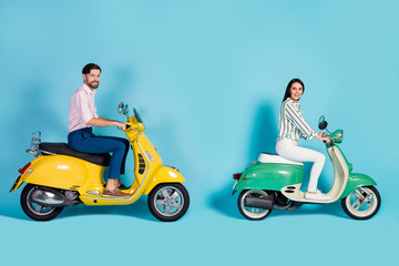 Fototapeta na wymiar Full length profile side photo positive wife husband bikers drive yellow green motorcycle enjoy street trip wear white striped shirt pink pants trousers isolated blue color background